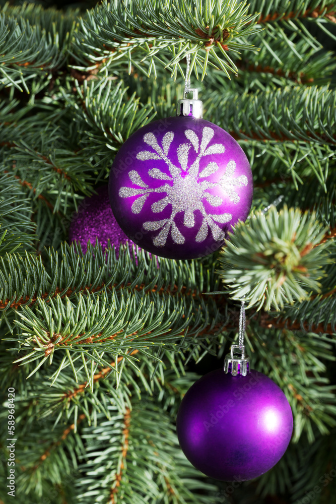 Christmas balls handing on a tree.