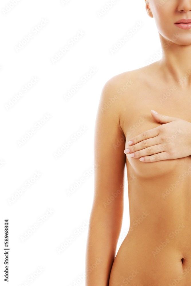 Fototapeta premium Young topless woman is examinning her breasts.