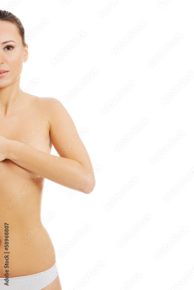 Fototapeta premium Young topless woman is examinning her breasts.
