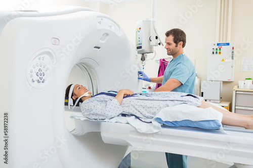 Nurse Preparing Patient For CT Scan In Hospital photo