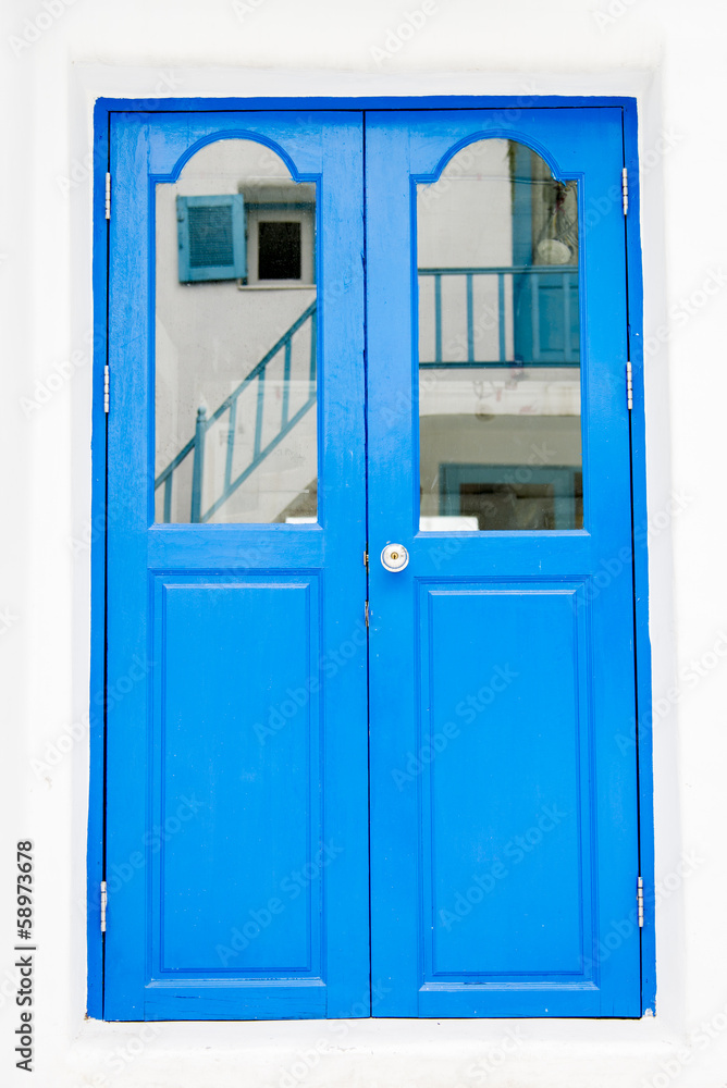 Blue wooden door on white wall