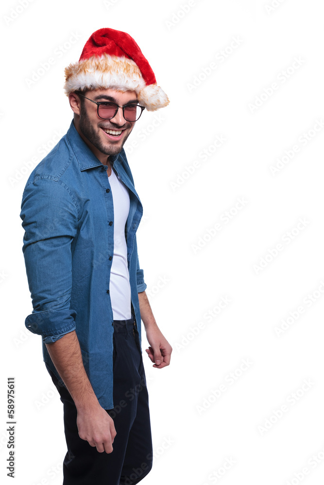 side a young man in jeans shirt and christmas hat side a young man in jeans shirt and christmas hat