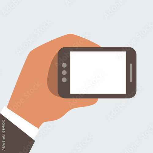 Businessman holding mobile phone with blank screen