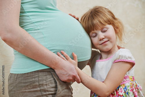 Canvas Print Pregnant woman belly and girl