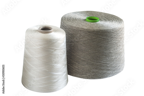 Silk and natural linen yarn bobbins isolated on white background