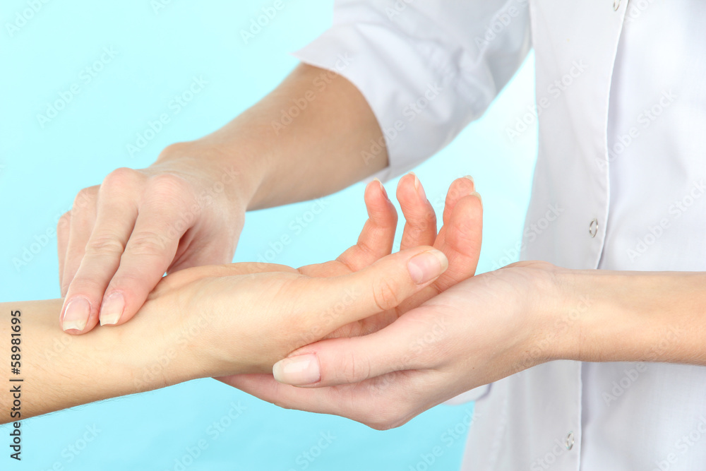 Measuring pulse on light blue background Measuring pulse on light blue background