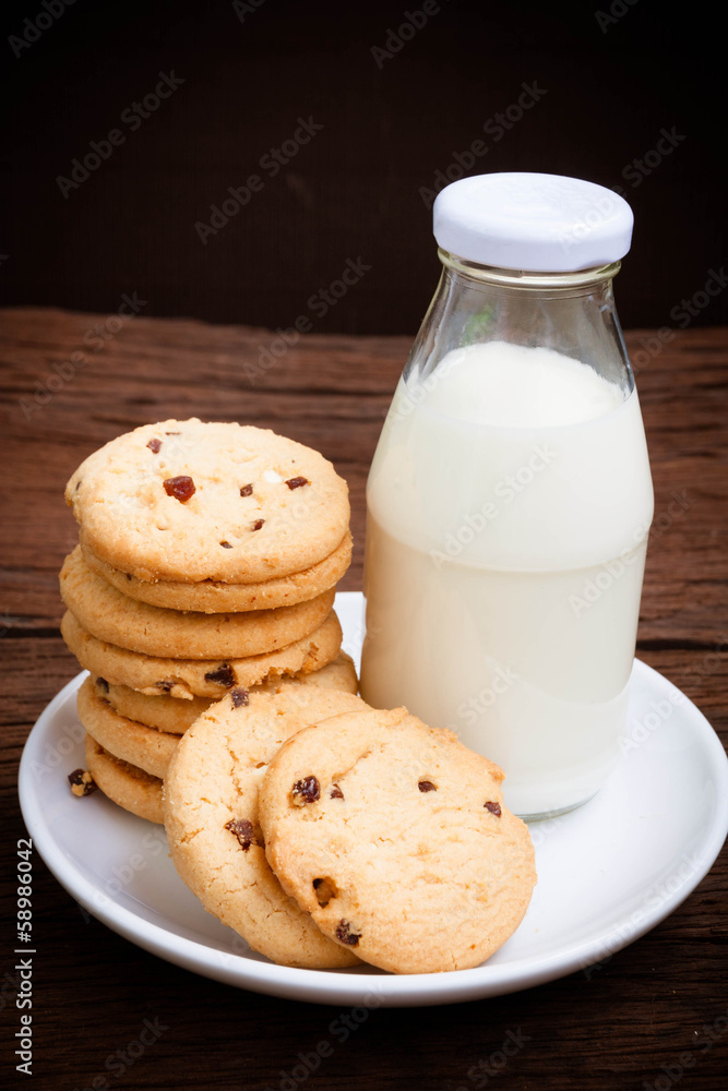 cookies and bottle milk on wood table cookies and bottle milk on wood table