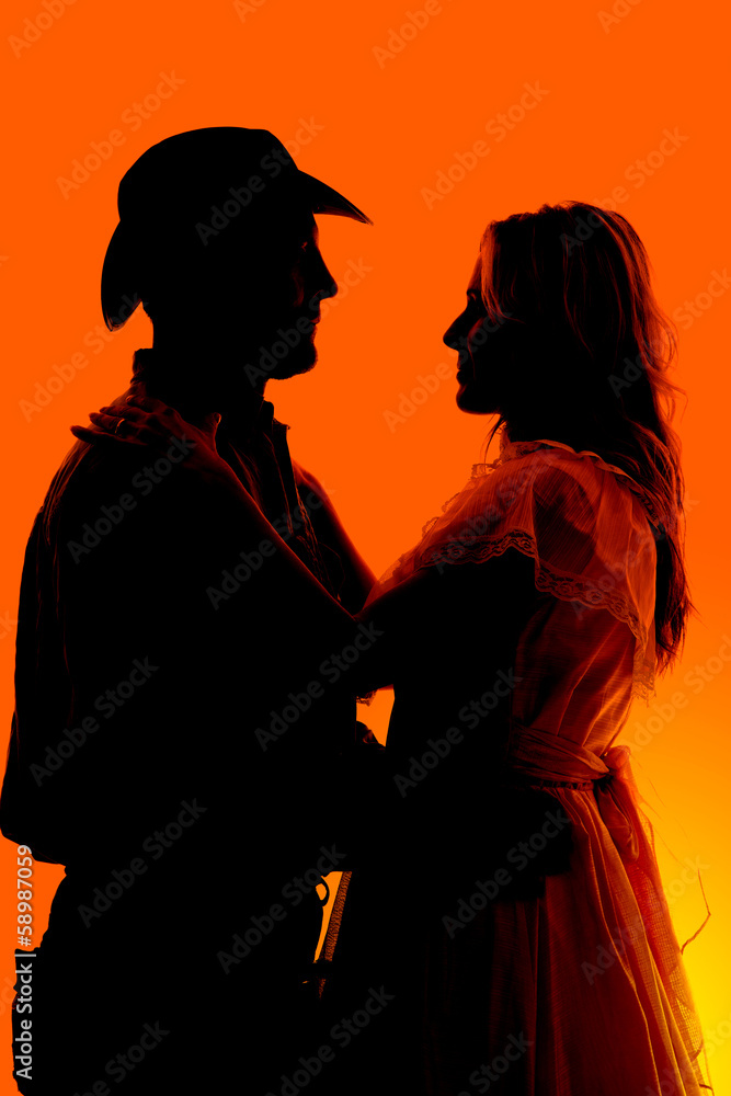 silhouette western couple holding each other