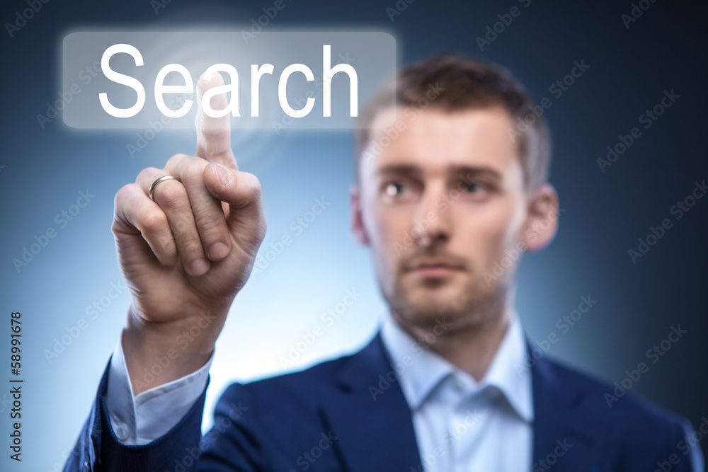 Obraz premium business man pressing Search button on touchscreen