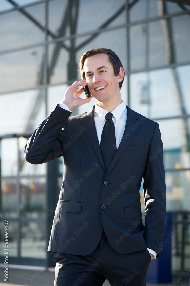 Businessman smiling and calling by mobile phone outdoors Businessman smiling and calling by mobile phone outdoors