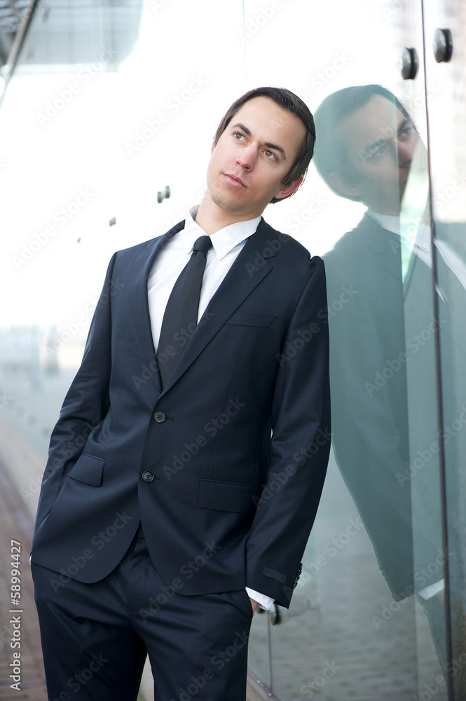 Businessman standing outdoors in suit