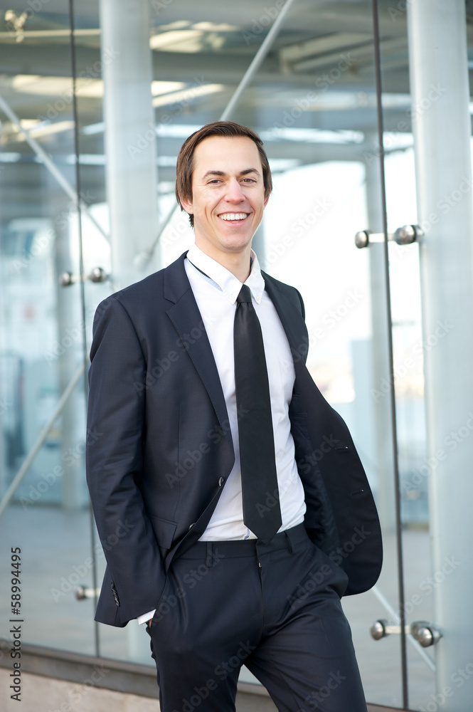 Portrait of a smiling businessman walking in the city Portrait of a smiling businessman walking in the city