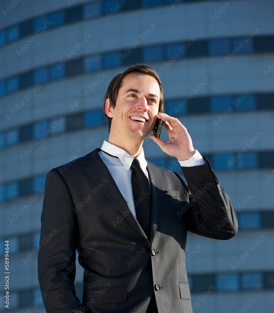 Portrait of a young business man talking on cellphone outdoors Portrait of a young business man talking on cellphone outdoors