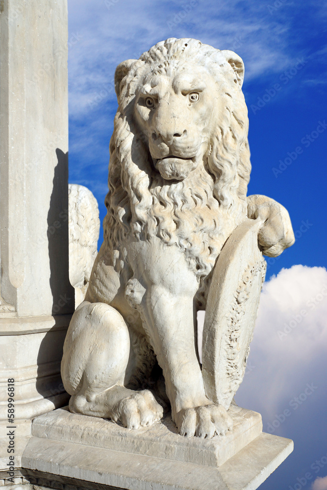 statue of lion on a background of blue sky