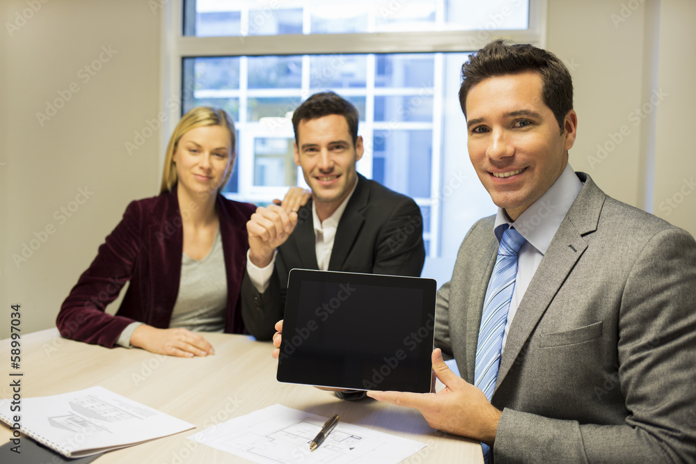 Real-estate agent presenting a new project on tablet pc Real-estate agent presenting a new project on tablet pc