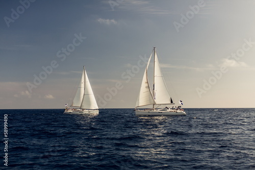 Sailing ship yachts with white sails
