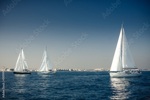 Sailing ship yachts with white sails