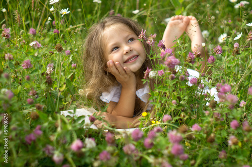 Girl whis a book in the grass