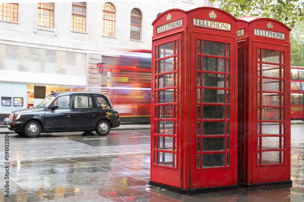 Red Phone cabines in London and vintage taxi.Rainy day. - obrazy, fototapety, plakaty 