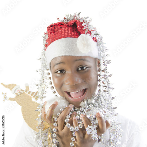 Little girl playing with Christmas decorations photo