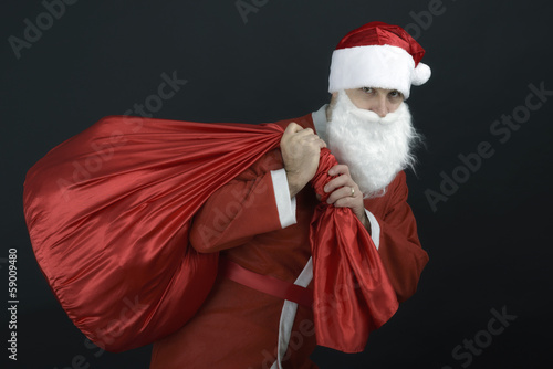 Santa Claus with christmas sack isolated on black background