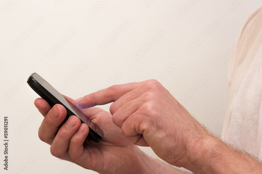 Young man using spartphone for networking on white background Young man using spartphone for networking on white background