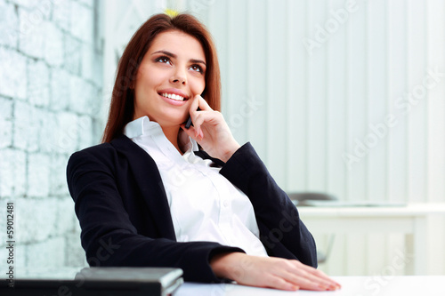 Young happy businesswoman talking on the phone  © Drobot Dean