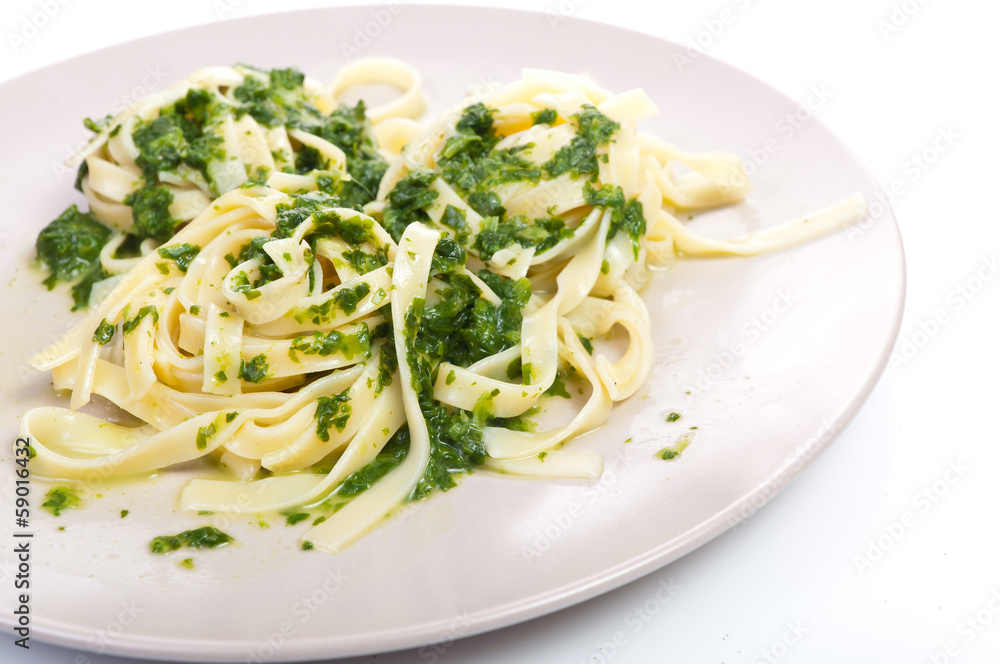 Tagliatelle with spinach on plate