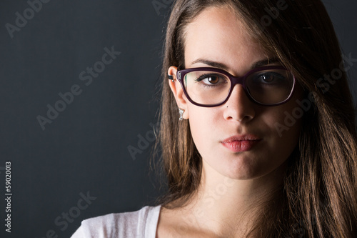 Pensive Young Woman on Dark Background