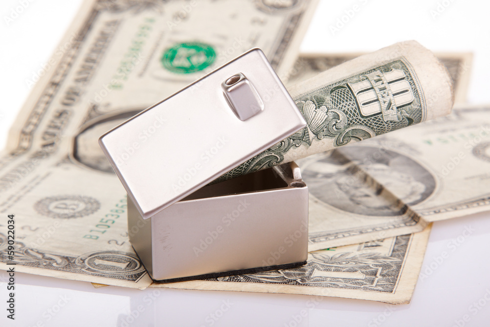 Naklejka premium Many dollar banknotes, house model; concept of buying a house