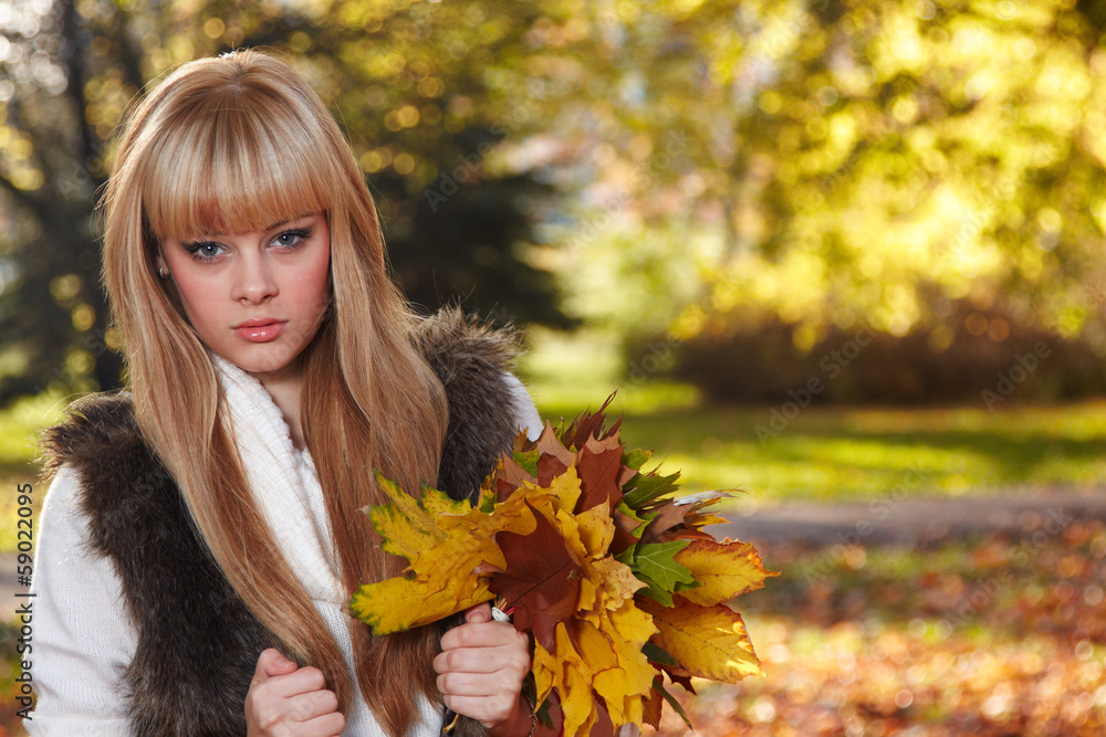 Young woman with autumn garden background Young woman with autumn garden background