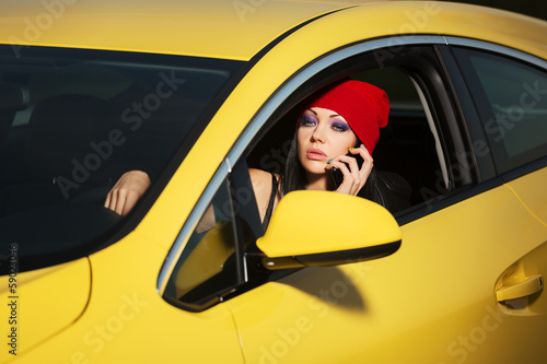 Young woman calling on cell phone in a car © Wrangler