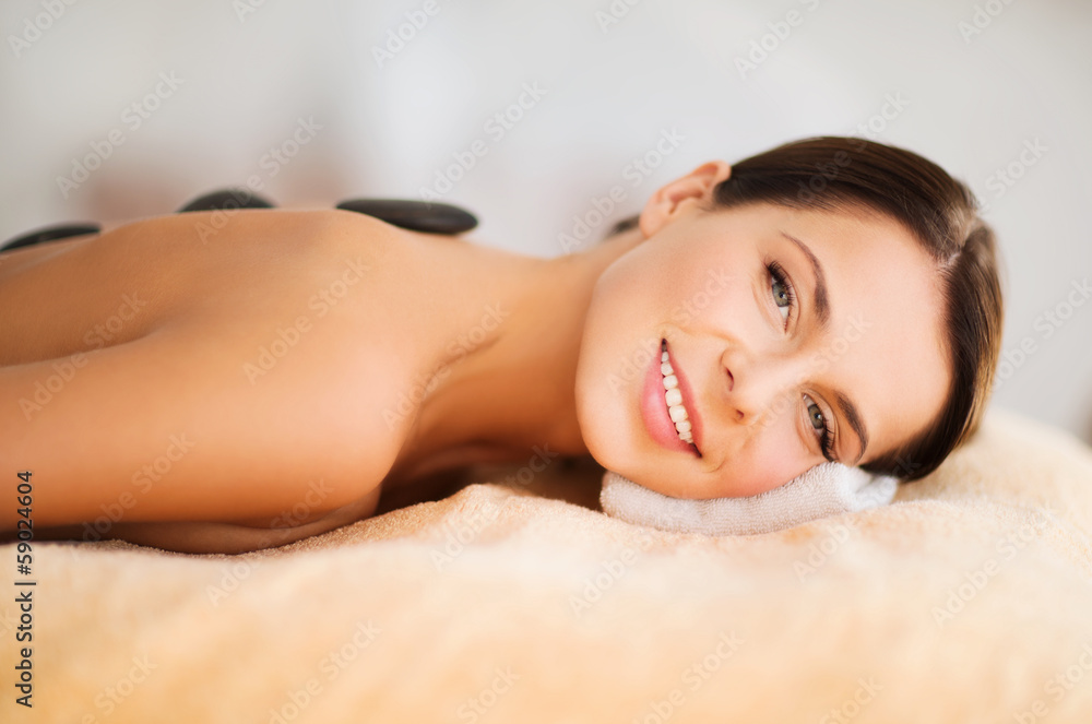 beautiful woman in spa salon with hot stones beautiful woman in spa salon with hot stones