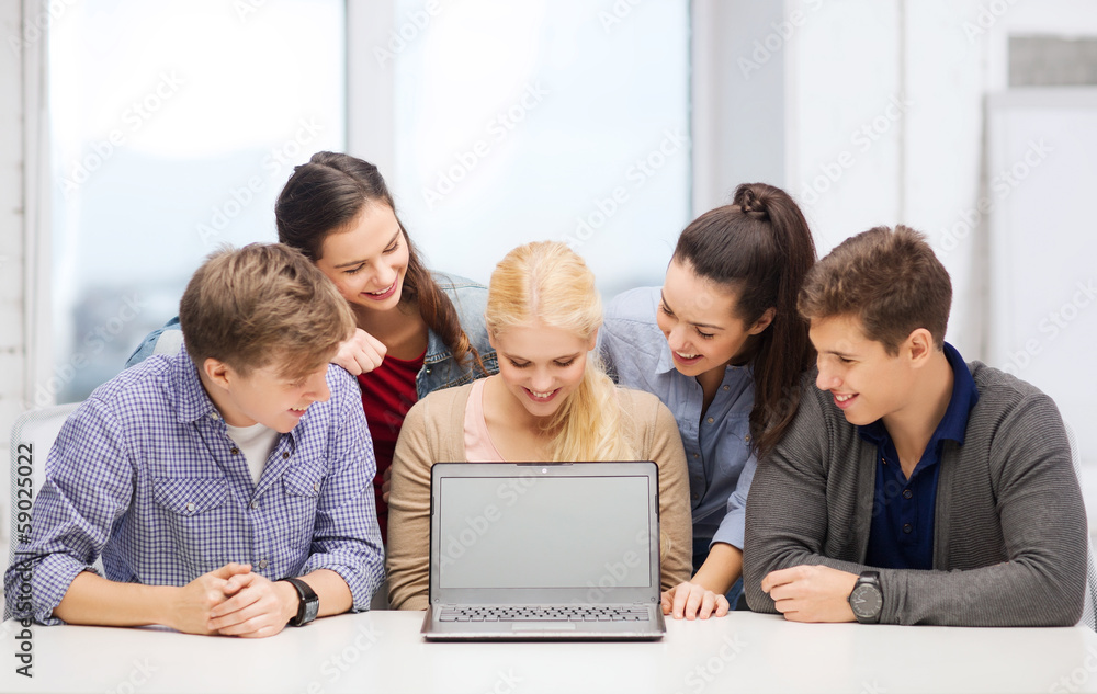 smiling students looking at blank lapotop screen smiling students looking at blank lapotop screen