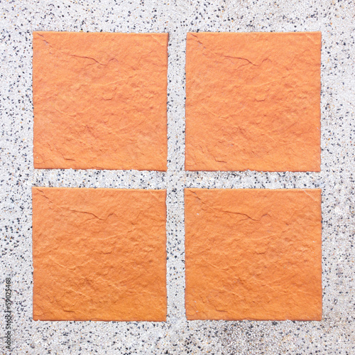 An Arrangement of four tiles on pebble background