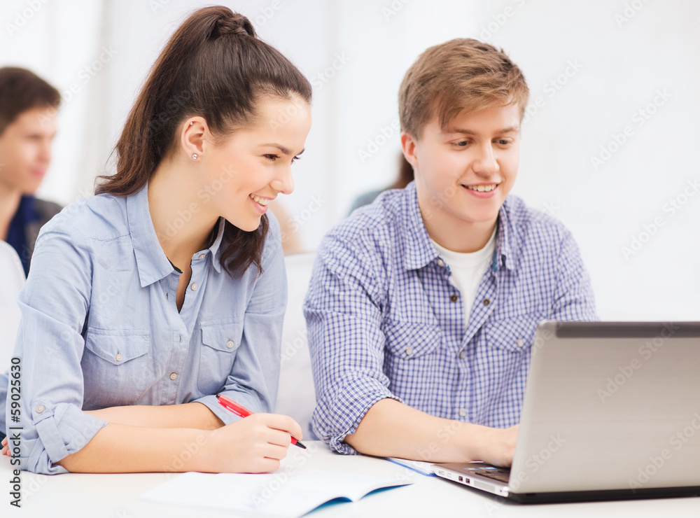 Fototapeta premium students with laptop and notebooks at school
