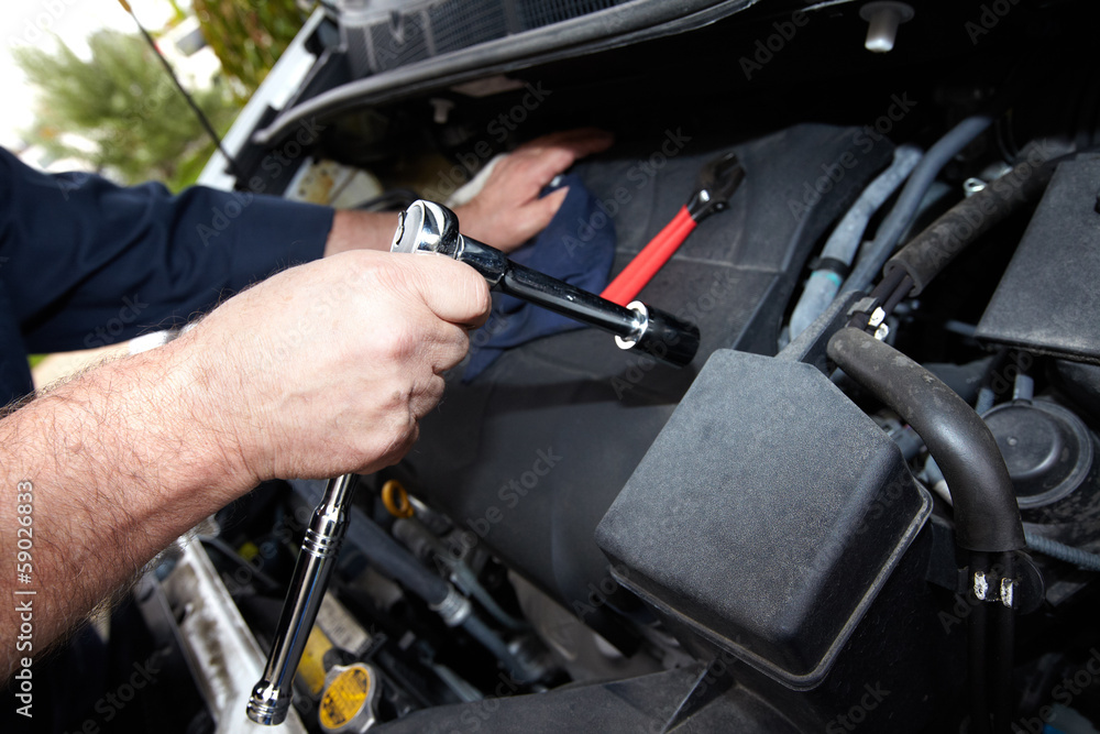 Hands of auto mechanic with wrench. Hands of auto mechanic with wrench.