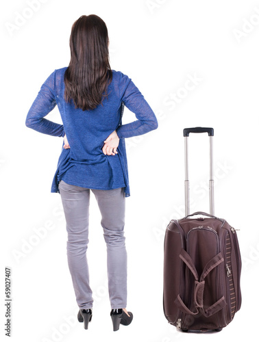 back view of standing young beautiful brunette woman.