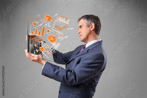 Businessman holding notebook with graphs and statistics