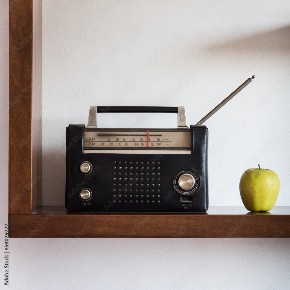 Fototapeta premium Vintage radio with yellow apple