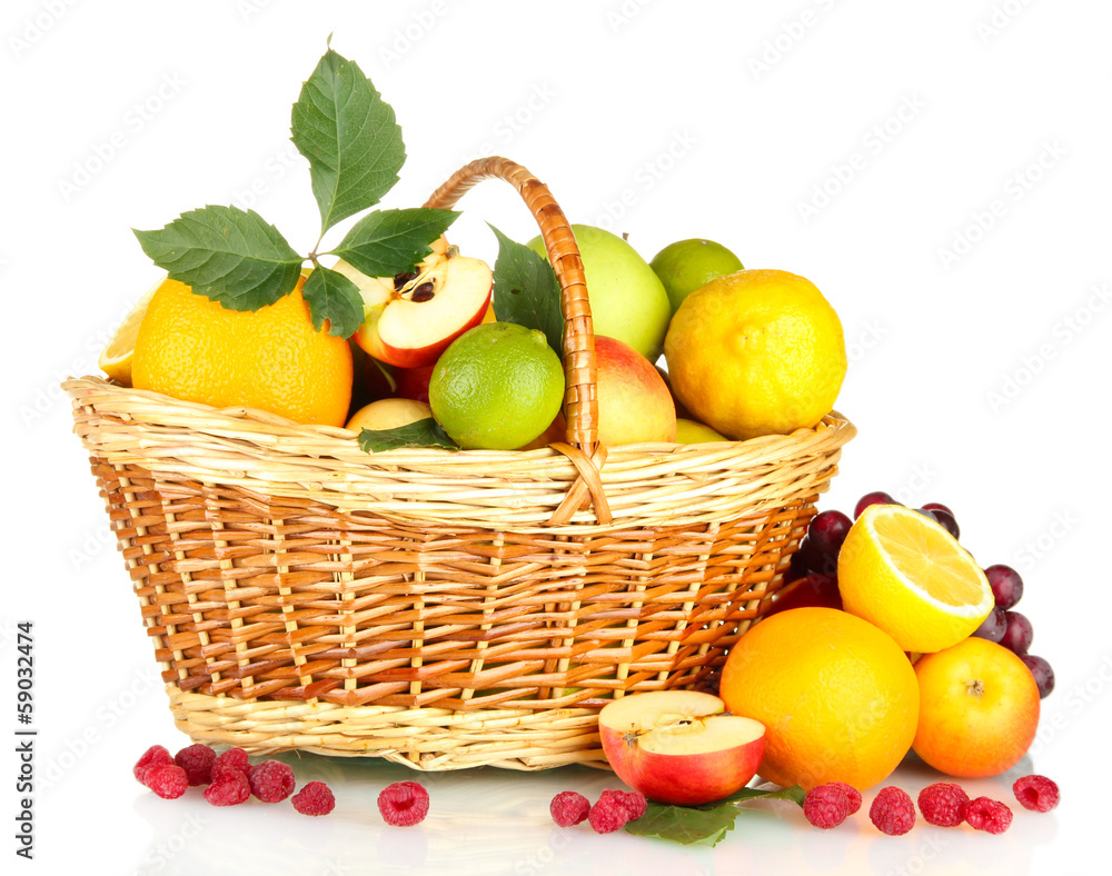 Assortment of exotic fruits in basket, isolated on white