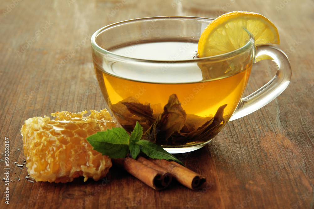 Transparent cup of green tea with honey and cinnamon Transparent cup of green tea with honey and cinnamon