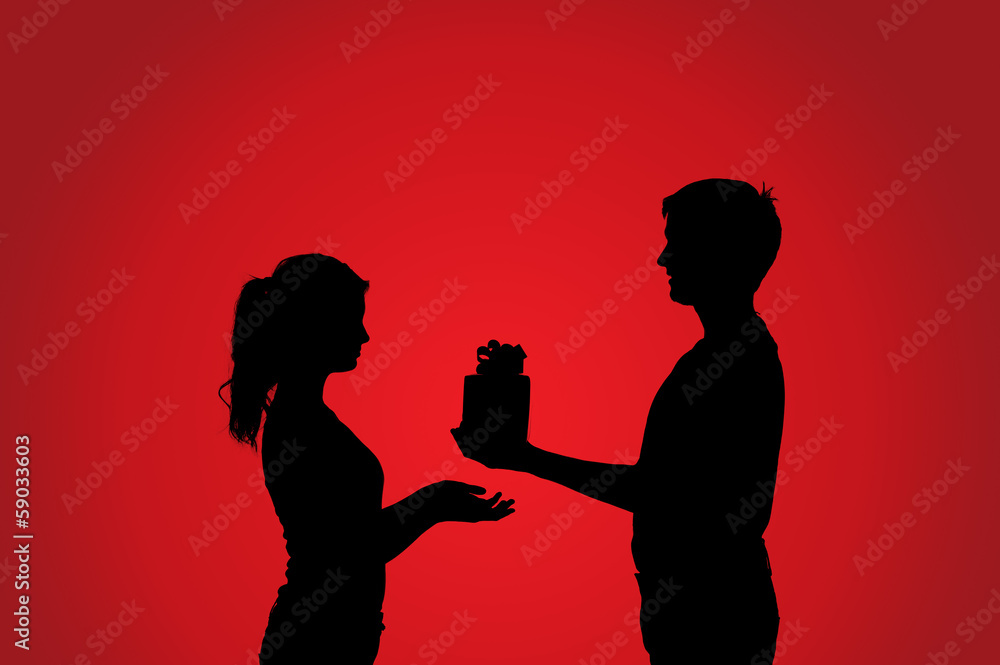 Silhouettes of couple with gift