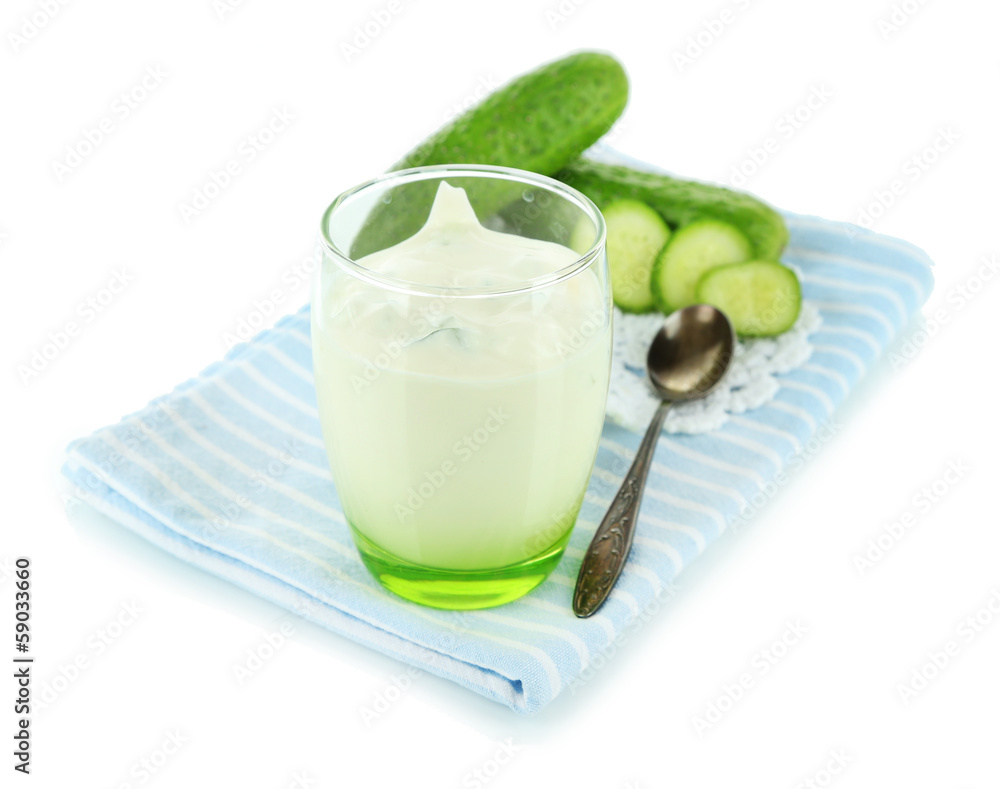 Cucumber yogurt in glass, on color napkin, isolated on white Cucumber yogurt in glass, on color napkin, isolated on white