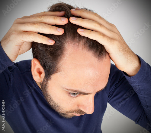 Принти на полотні Man controls hair loss