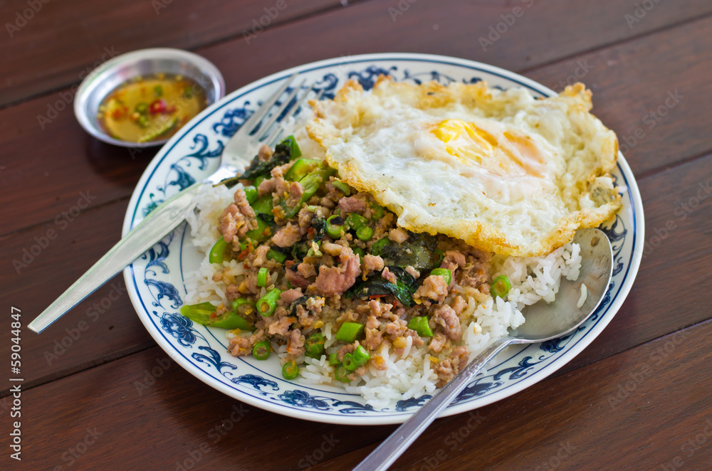 Stir fried pork with basil and egg on rice