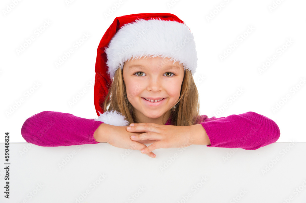Beautiful little girl in Santa Claus hat smiling on camera