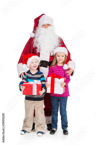 Old Santa Claus hugging little boy and girl with presents