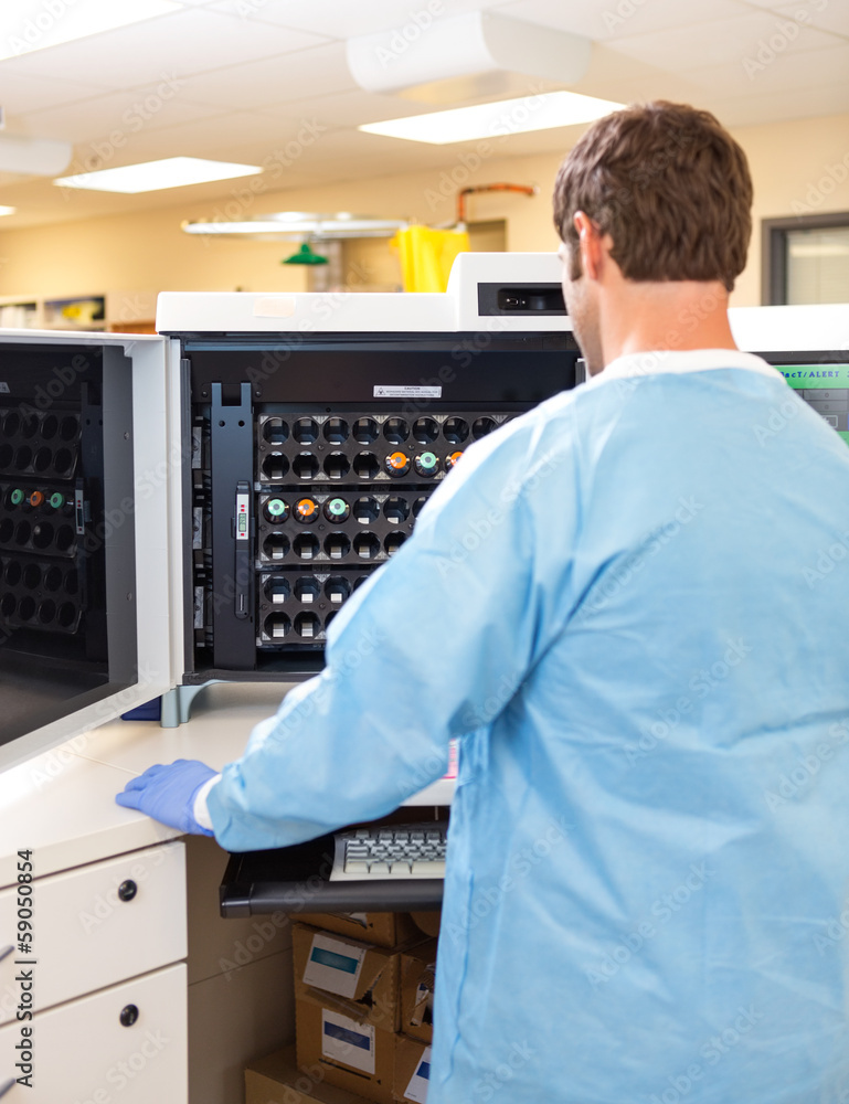 Lab Tech Working with Hematology Analyzer Lab Tech Working with Hematology Analyzer