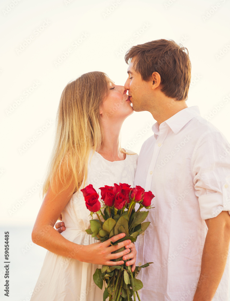 Romantic Young Couple in Love, Man holding surprise bouquet of r Romantic Young Couple in Love, Man holding surprise bouquet of r